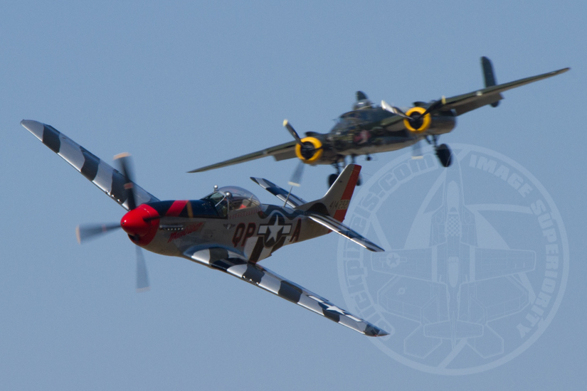 B-25 Executive Sweet is coming in to land while P-51D Man O War makes a high speed show pass.