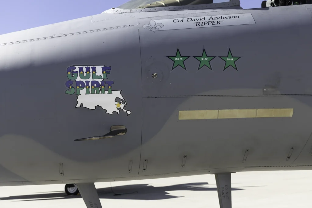 Close-up of a Louisiana Air National Guard F-15C Eagle showing Gulf Spirit nose art, pilot name, and green air-to-air victory stars representing enemy aircraft destroyed in combat.